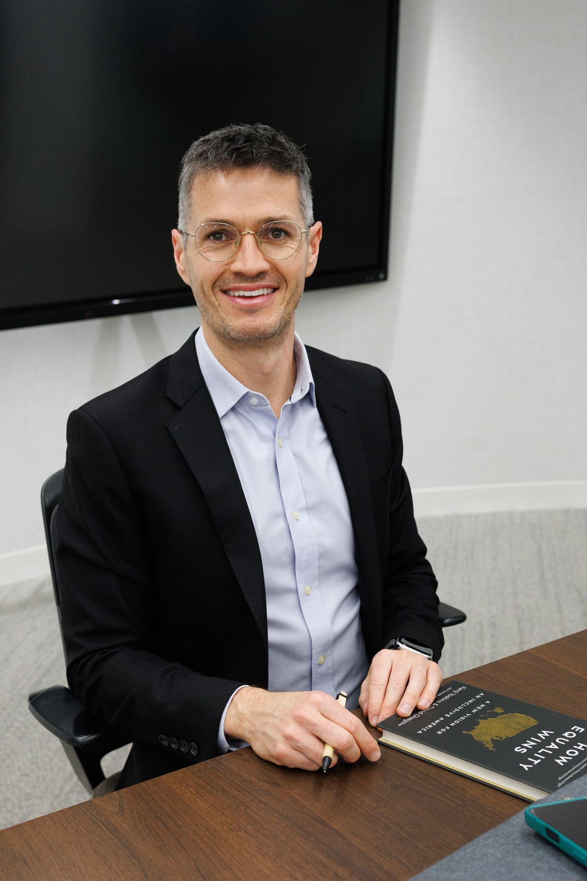 David Glasgow signs copies of How Equality Wins.