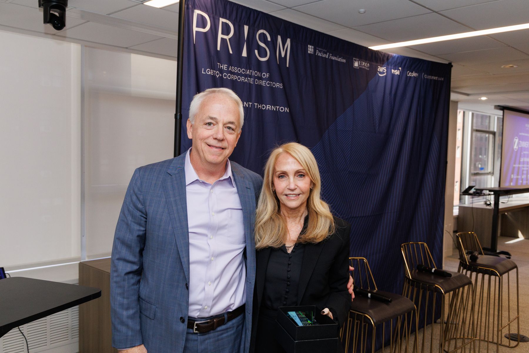 David Hedley presents a Profiles in Excellence award to Lori Winkler.